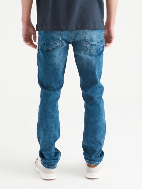 Regular washed blue jeans dark blue middle back view