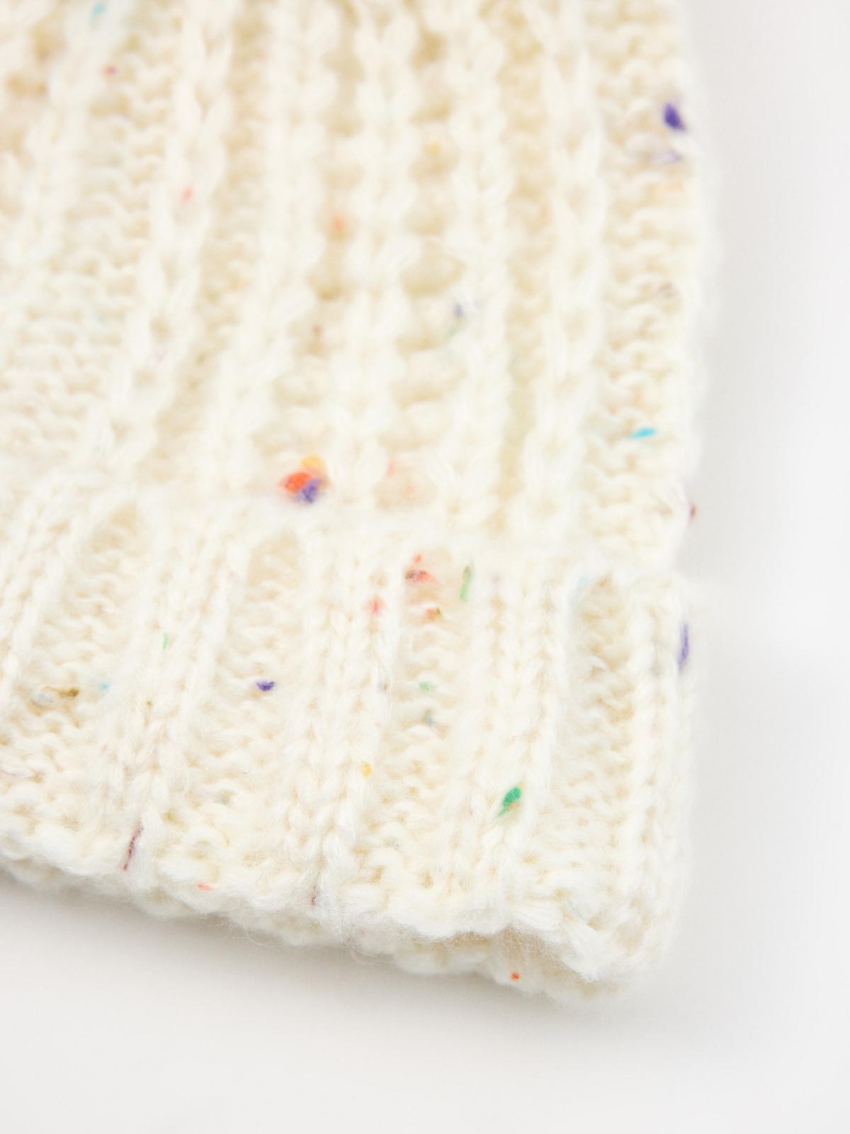 Multicolored mottled white cap white detail view
