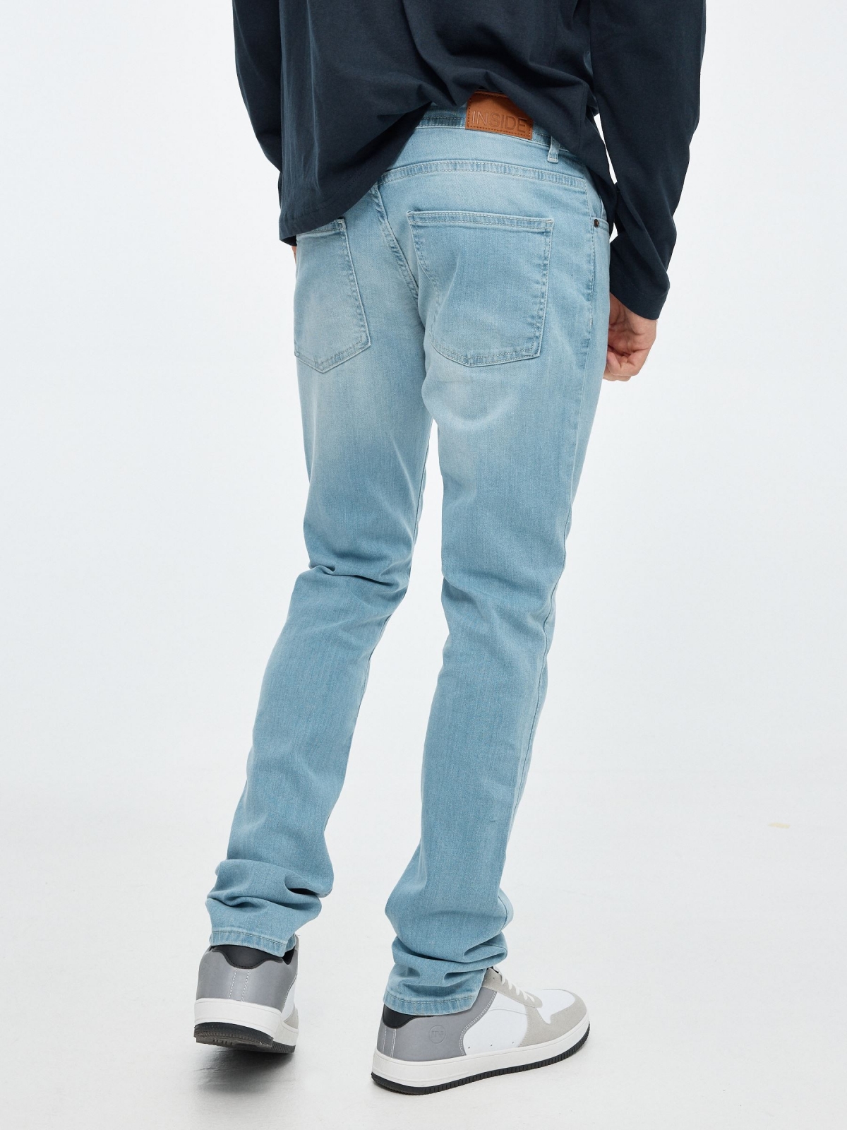 Light blue slim jeans dark blue middle back view