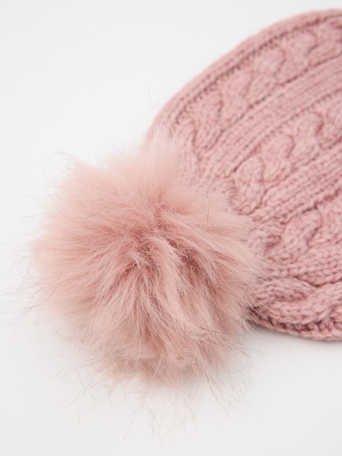 Pink braided hat with pompom design middle 45º front view