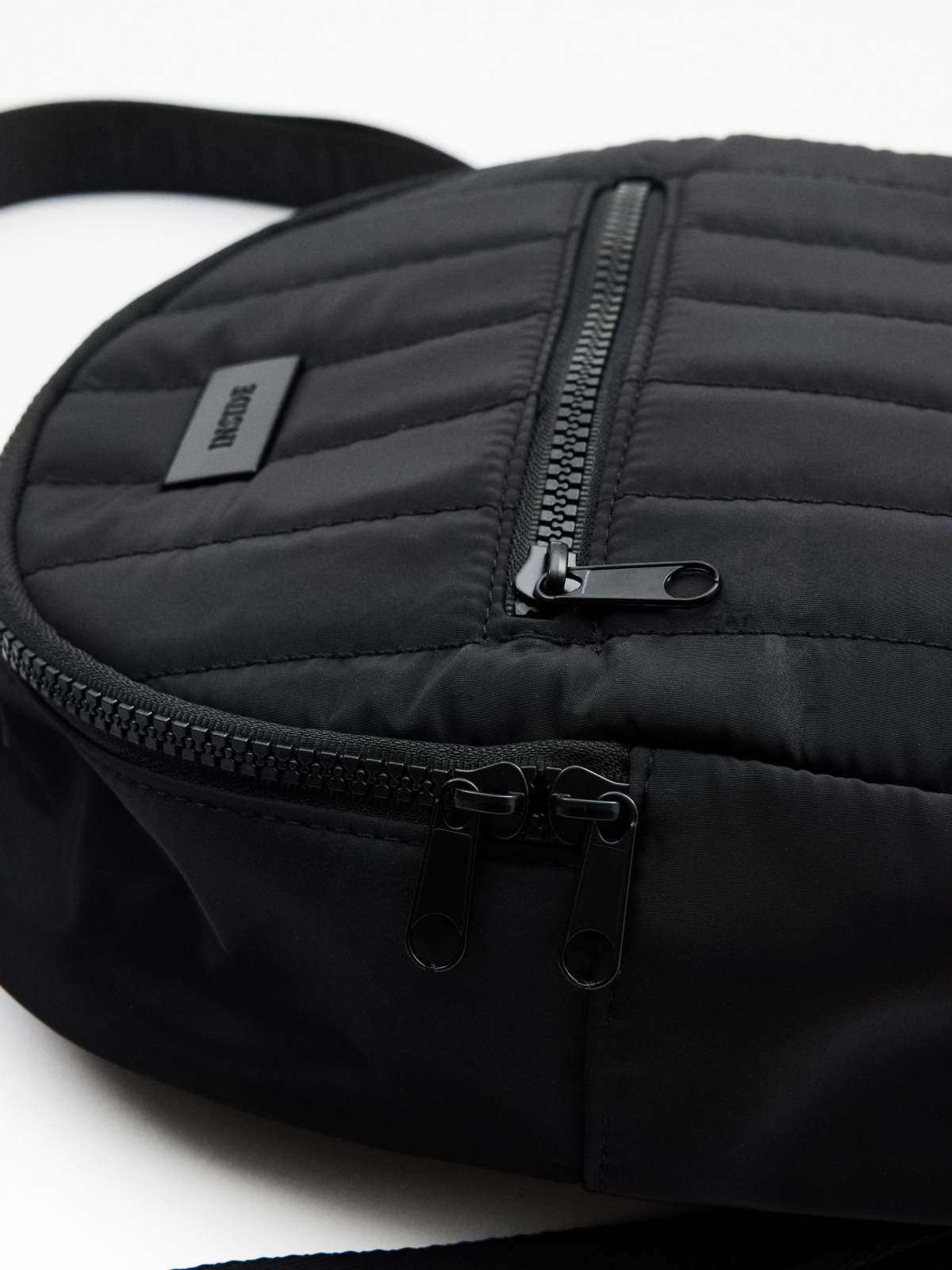 Quilted black backpack detail view