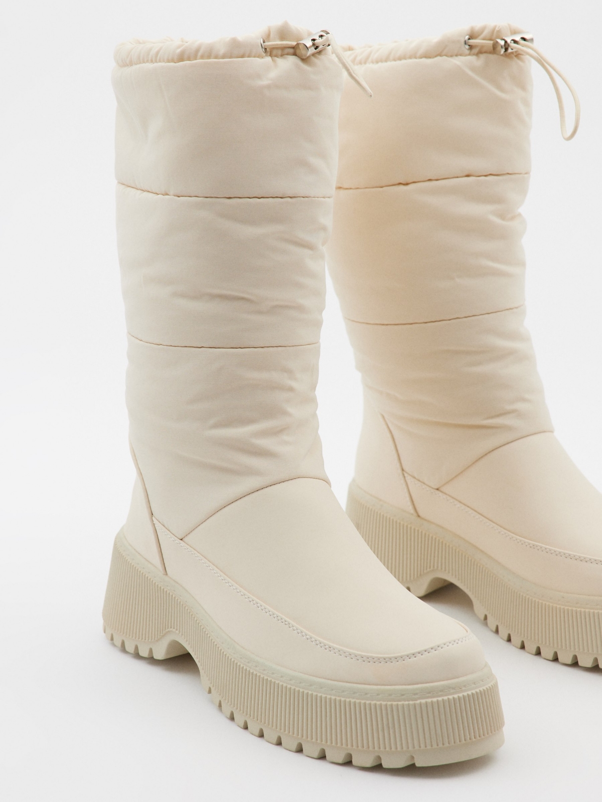 White padded boots beige with a model