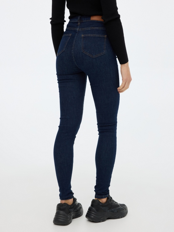 High rise skinny jeans dark blue middle back view