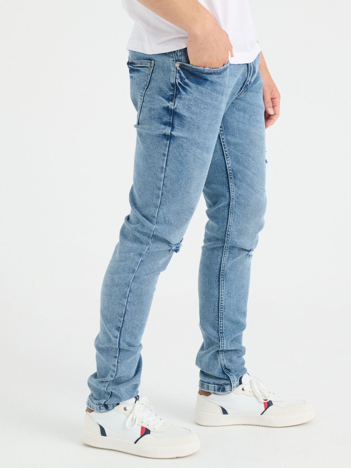 Ripped blue slim jeans blue detail view