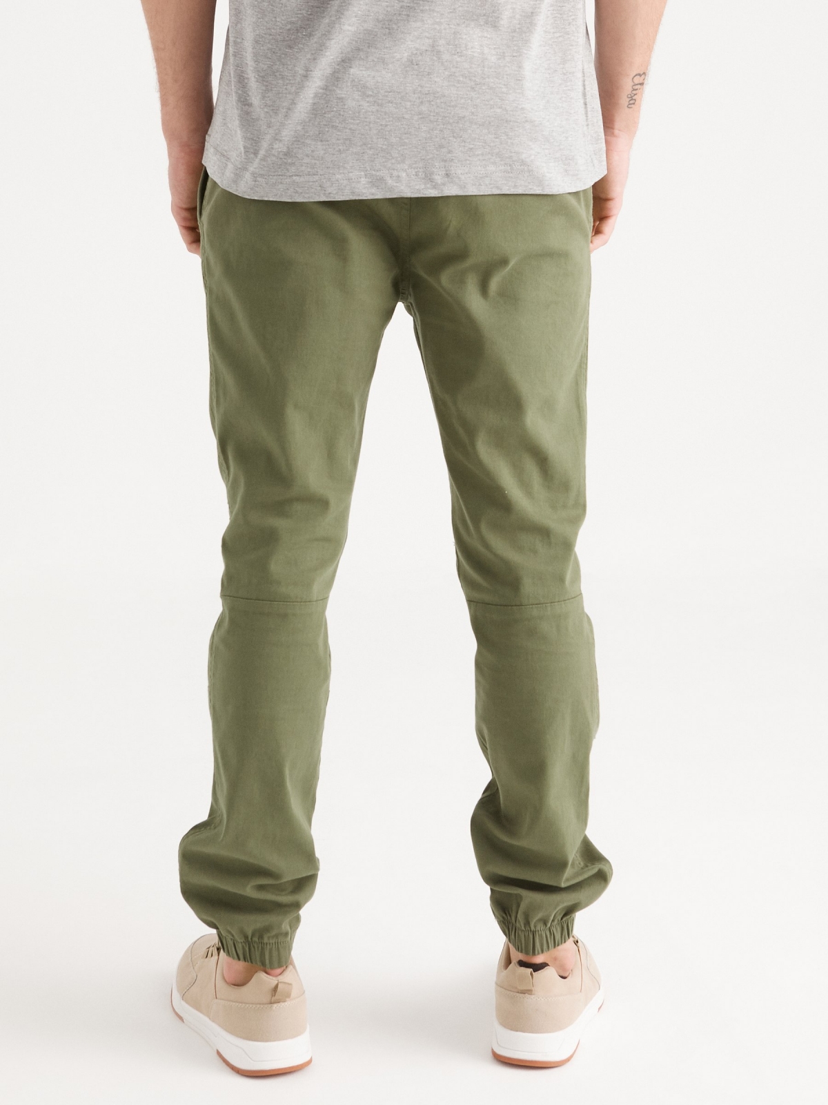 Joggers with seams green middle back view