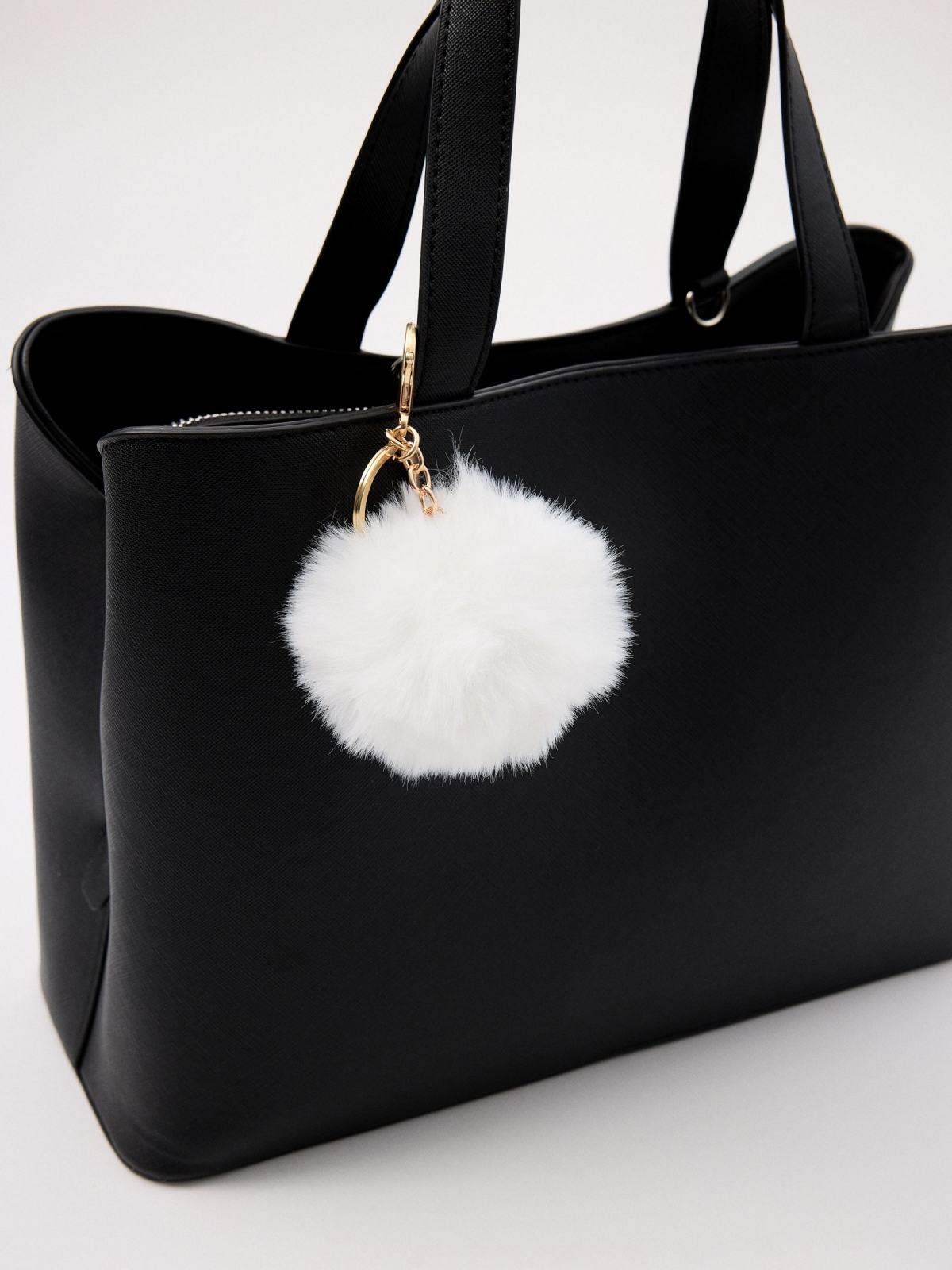 White pompom keychain detail view