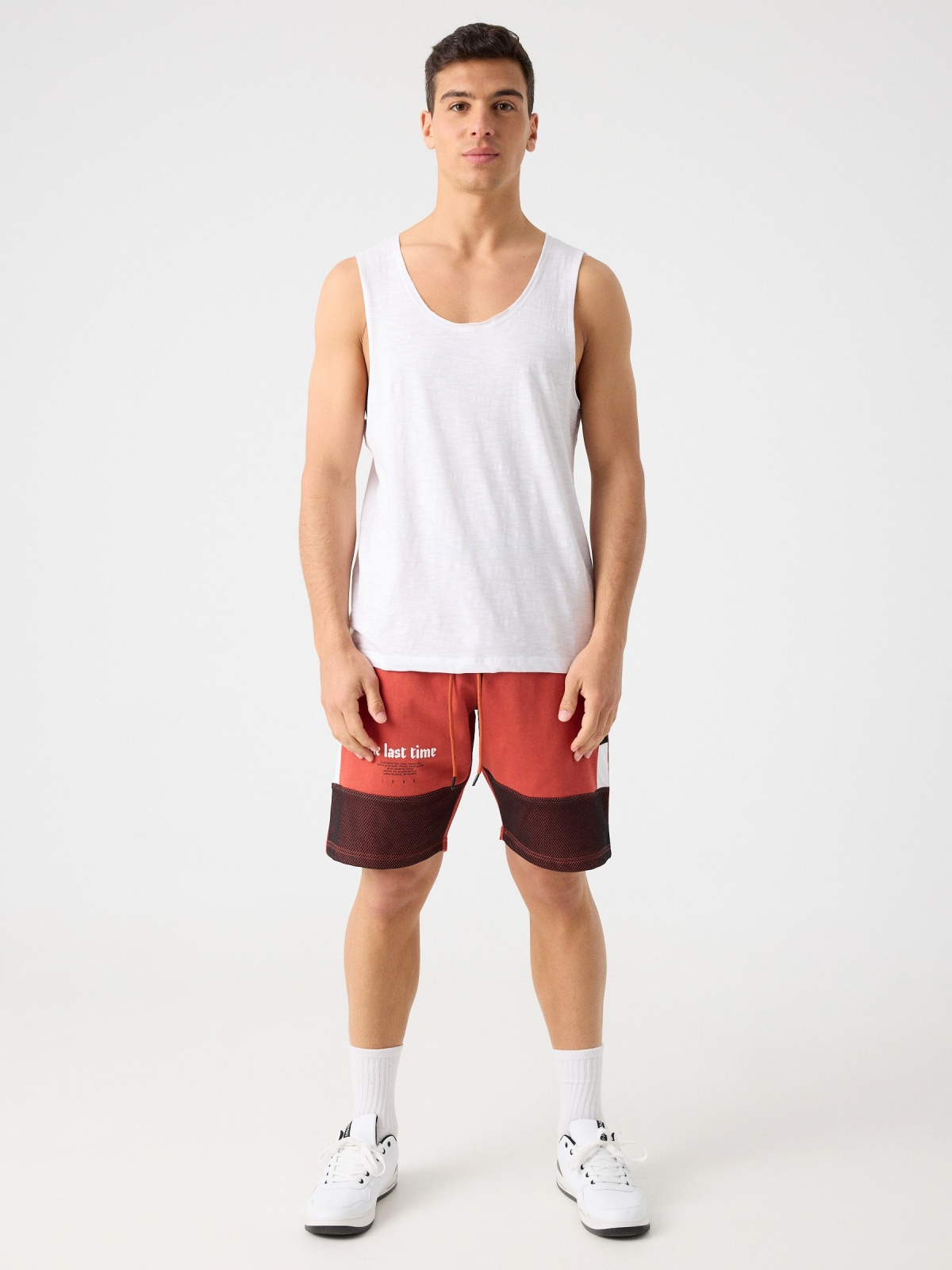 Combined bermuda jogger short with text orangish red front view
