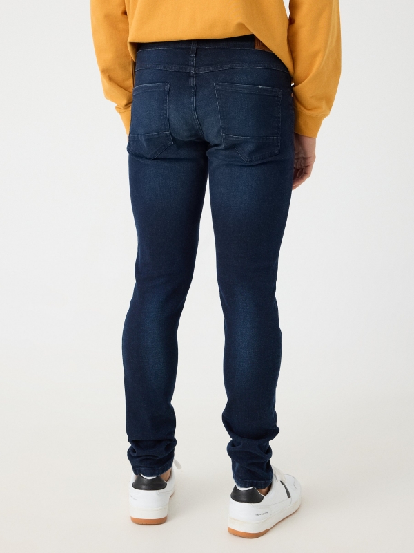 Ripped washed blue super slim jeans navy middle back view