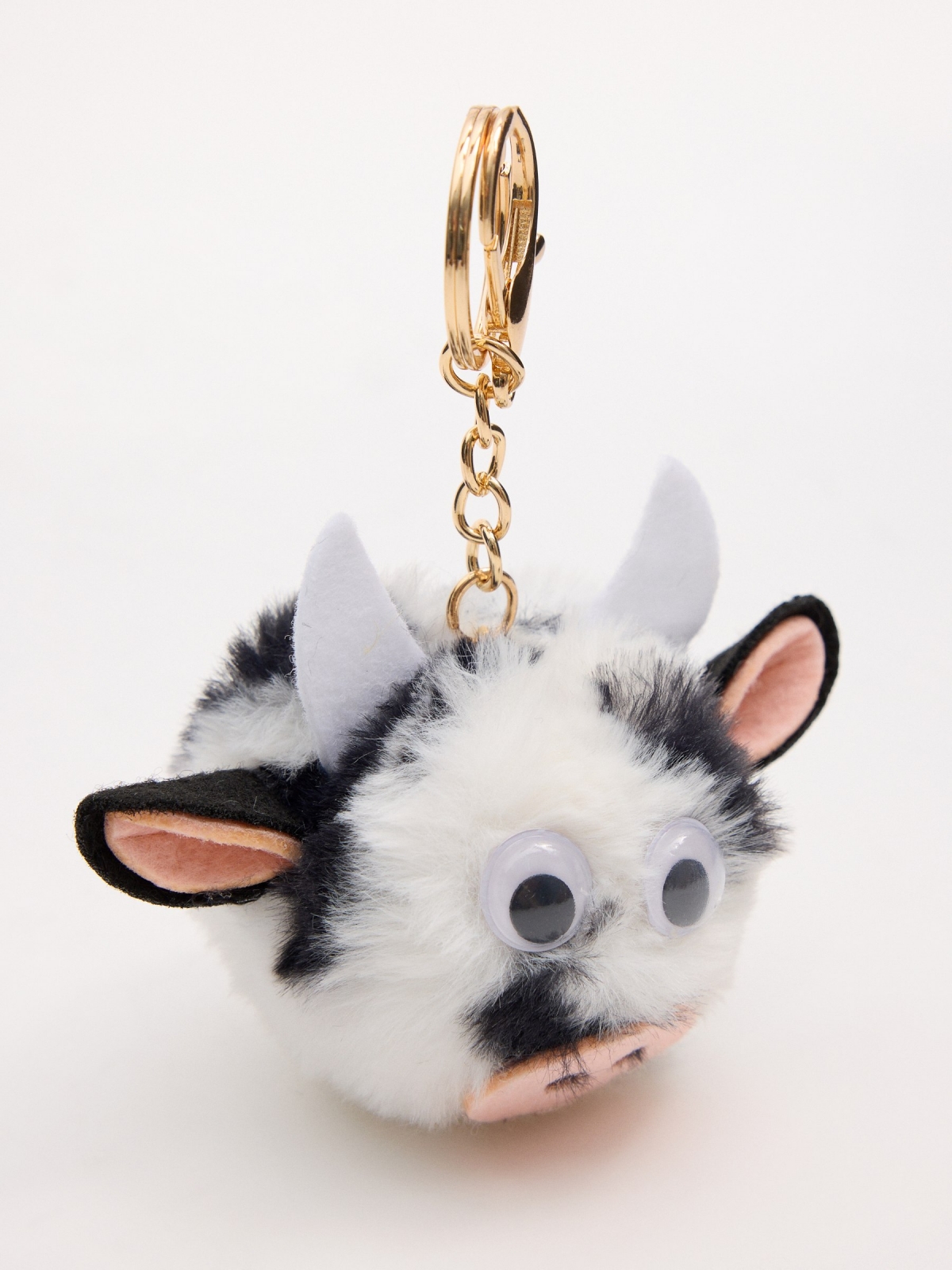 Cow pompom keychain foreground with a model