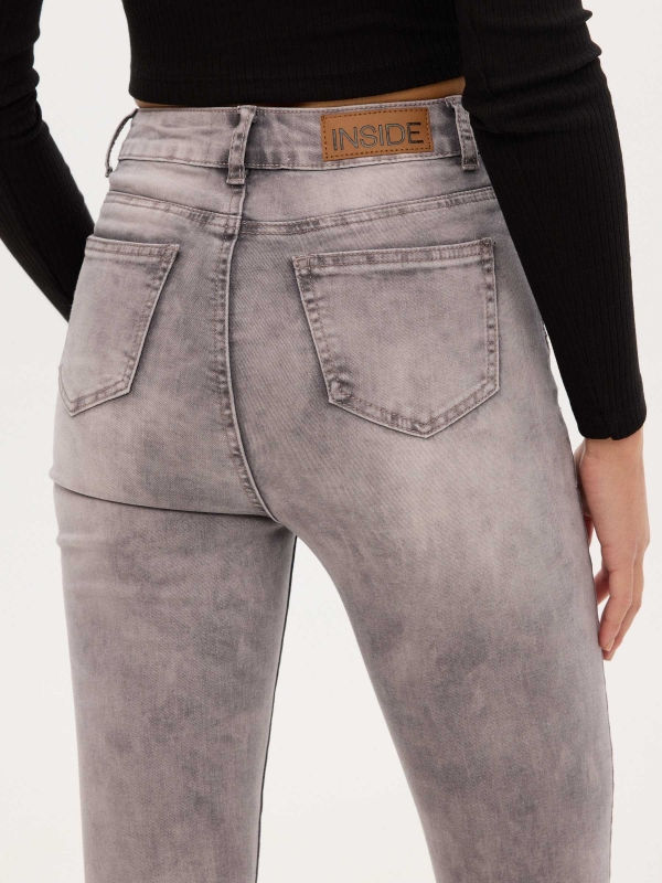 Worn high rise skinny jeans light grey detail view