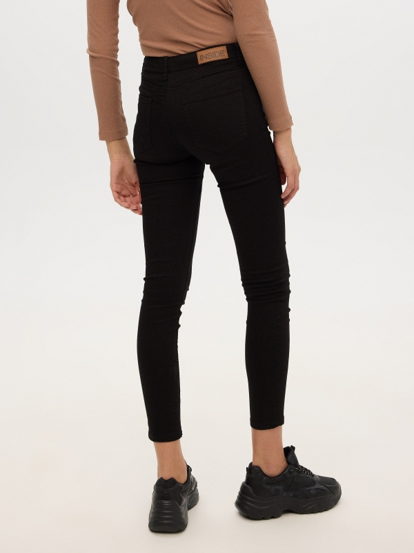 Mid rise skinny jeans black middle back view
