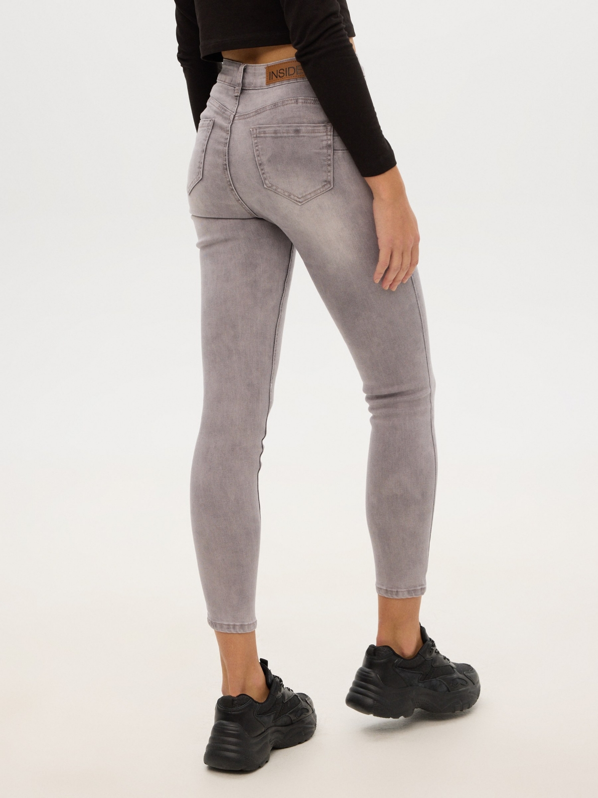 Worn push up skinny jeans light grey middle back view