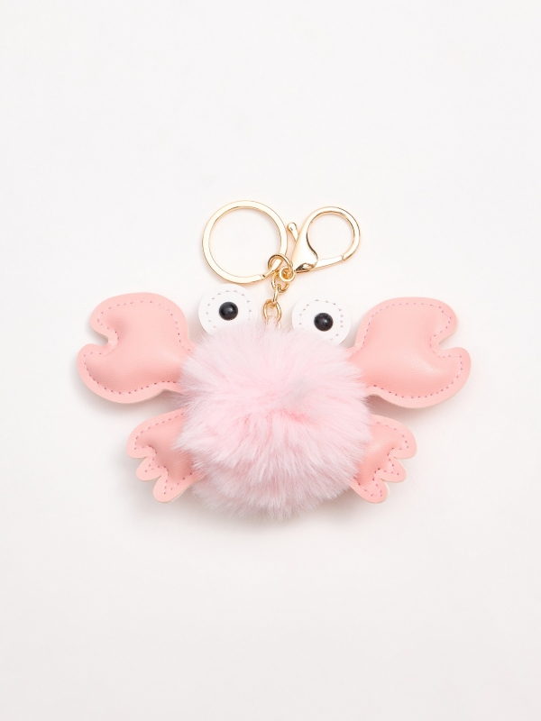 Crab pompom keychain foreground with a model