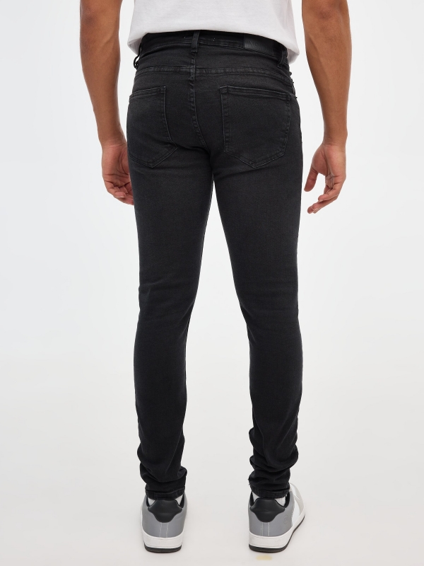Black skinny jeans black middle back view