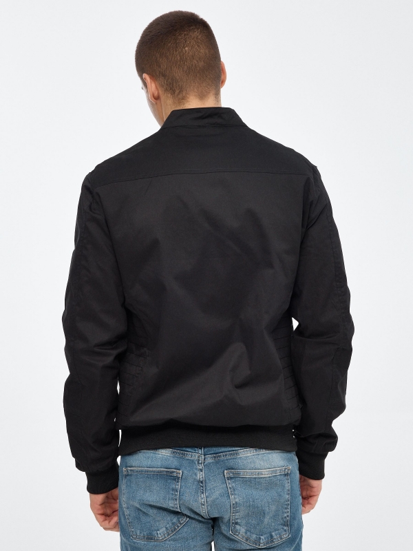 Black nylon jacket black middle back view