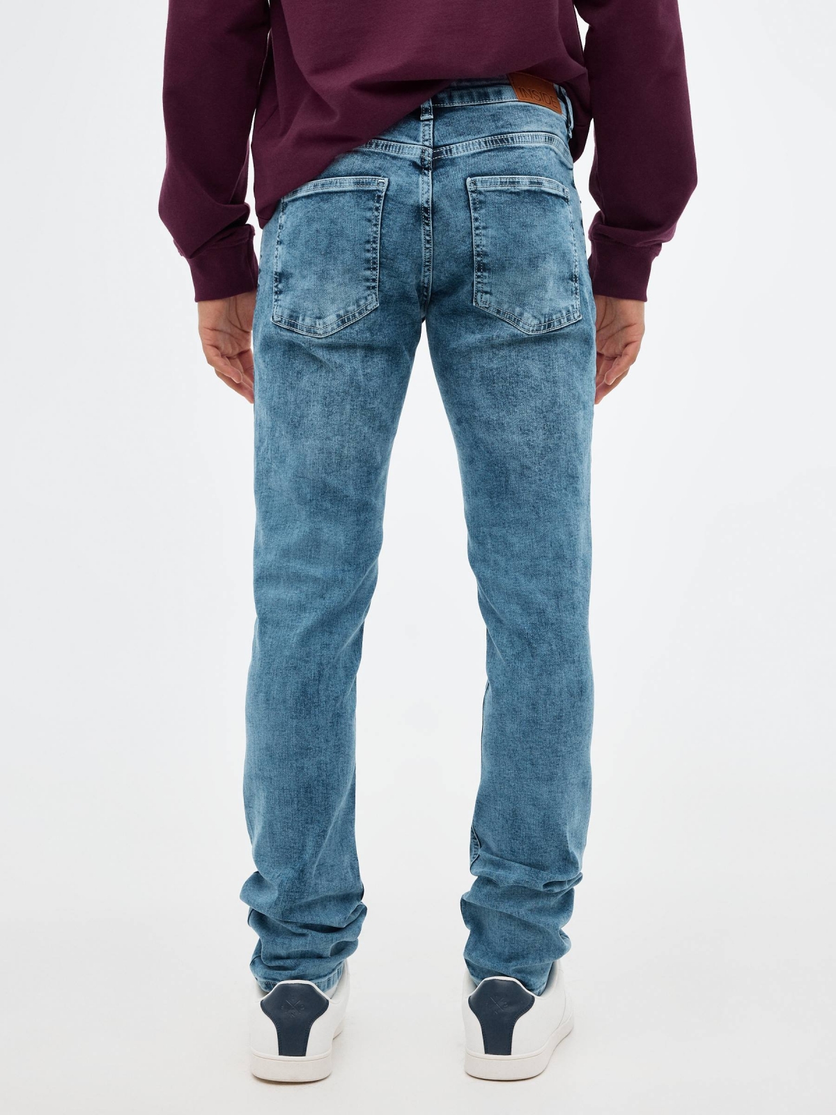 Worn out blue slim jeans blue middle back view