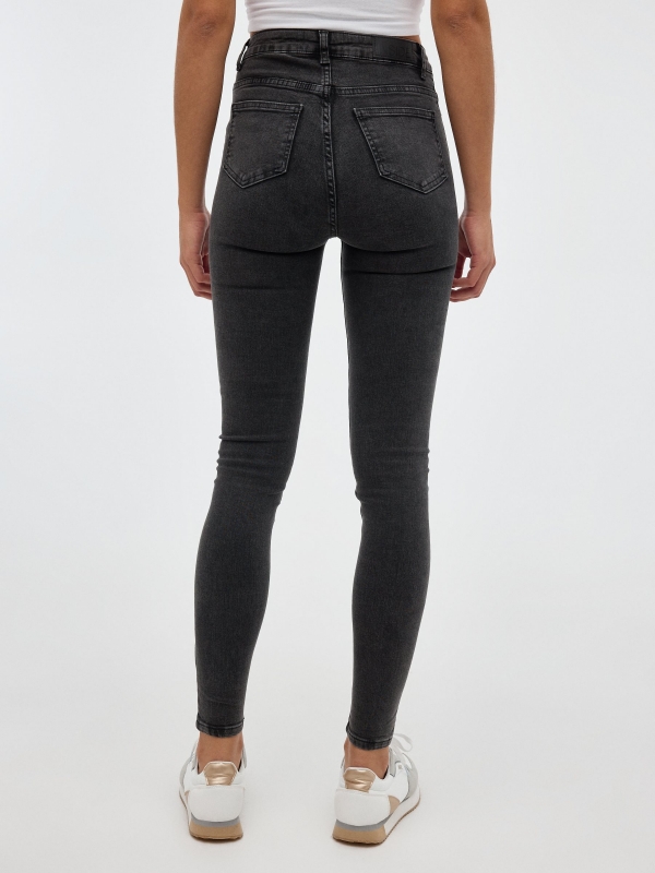 Dark gray skinny jeans black middle back view