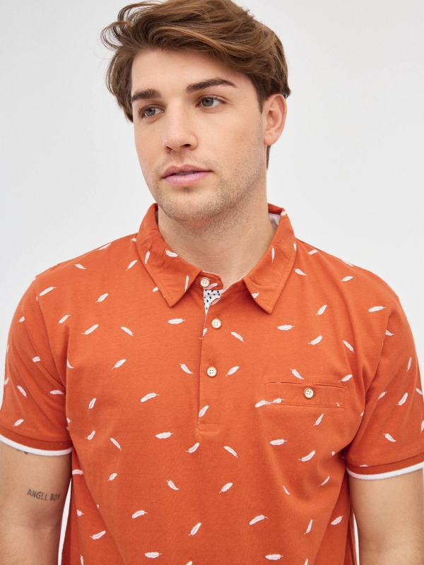 Feather print polo shirt brick red detail view