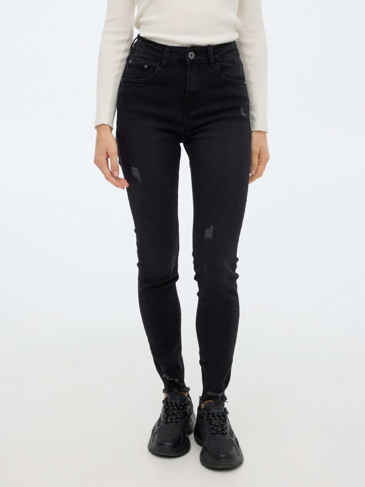 Worn skinny pants black middle front view
