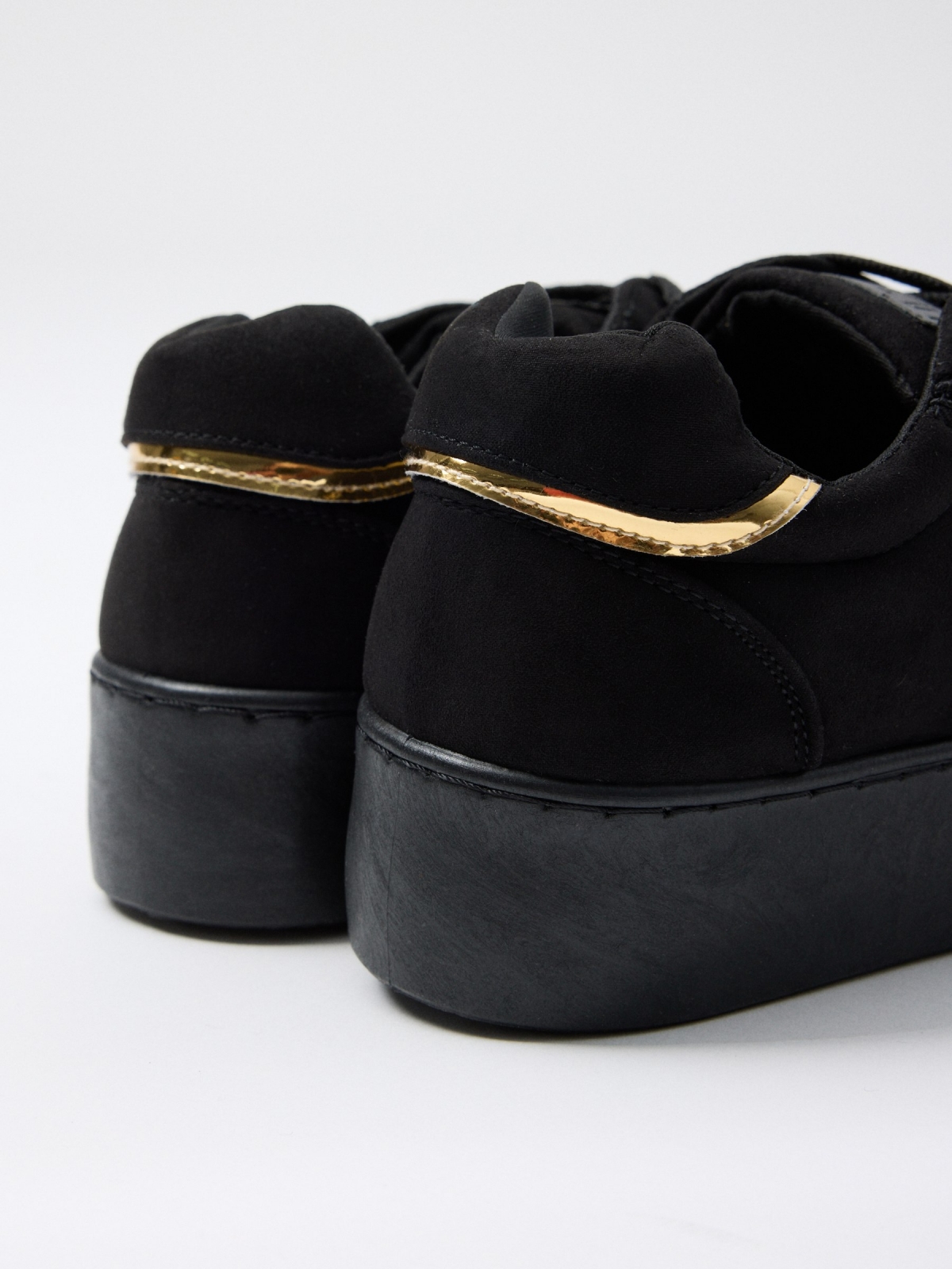 Black sneaker with platform black detail view