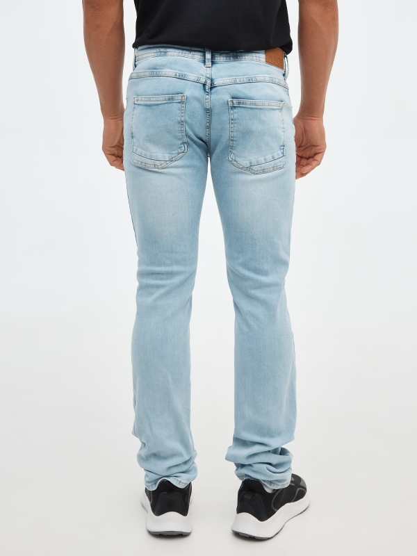 Ripped regular denim jeans blue front view