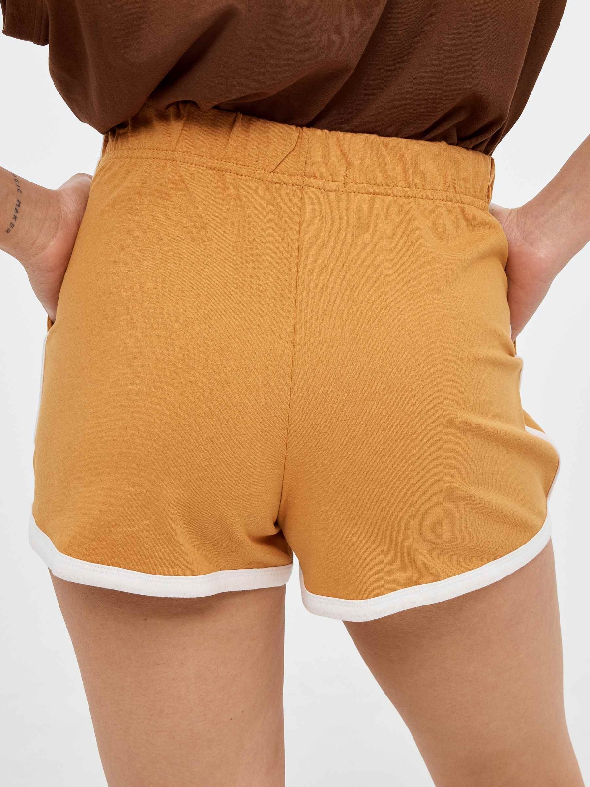Embroidered knitted shorts ochre detail view
