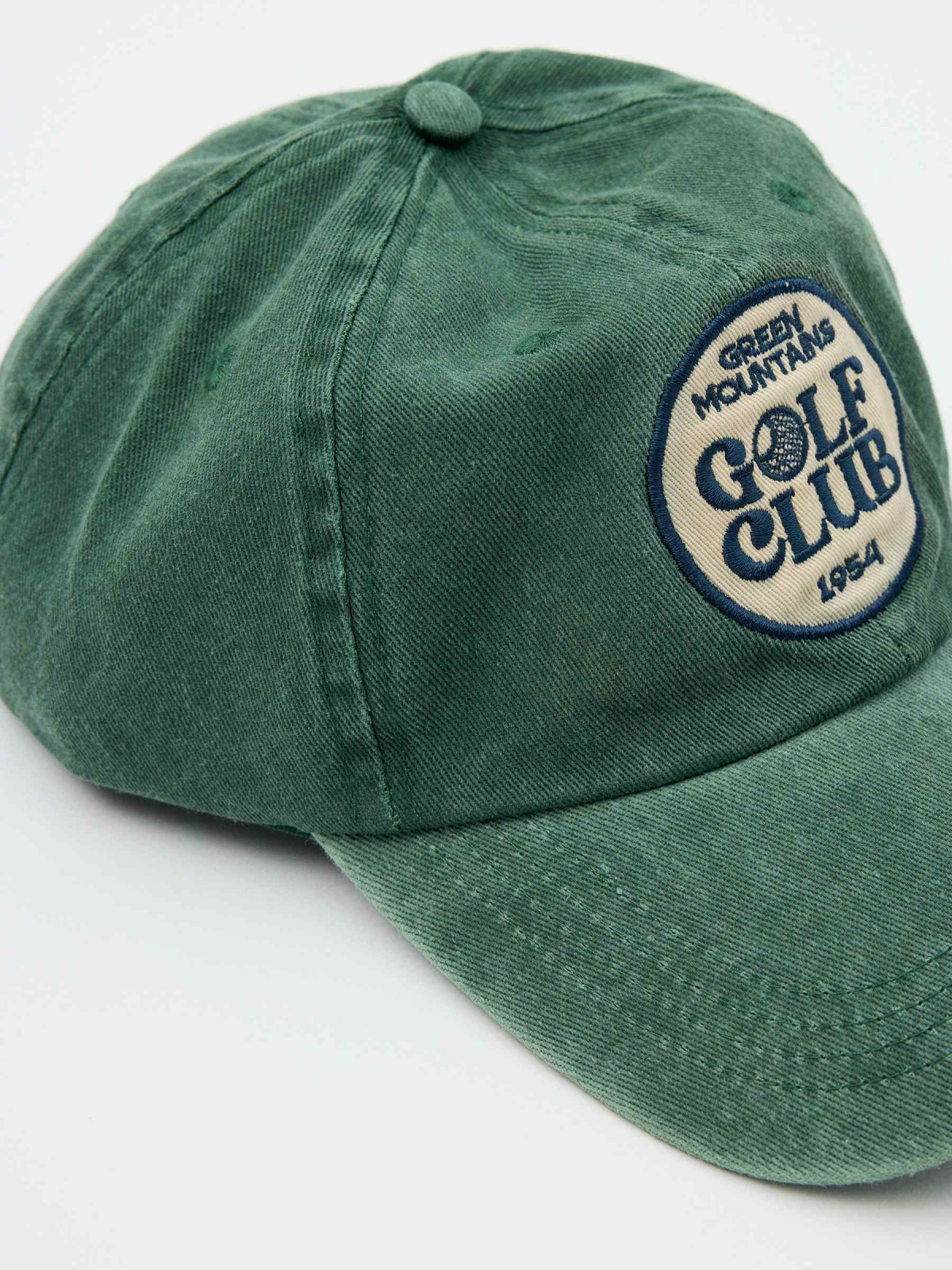 Baseball cap logo green detail view