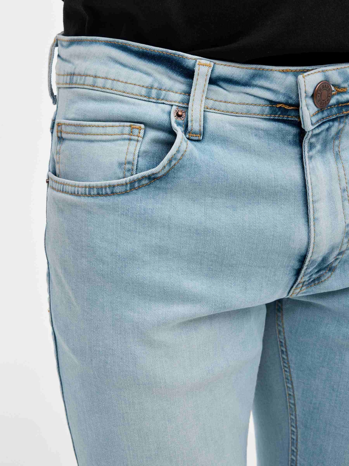 Ripped regular denim jeans blue foreground