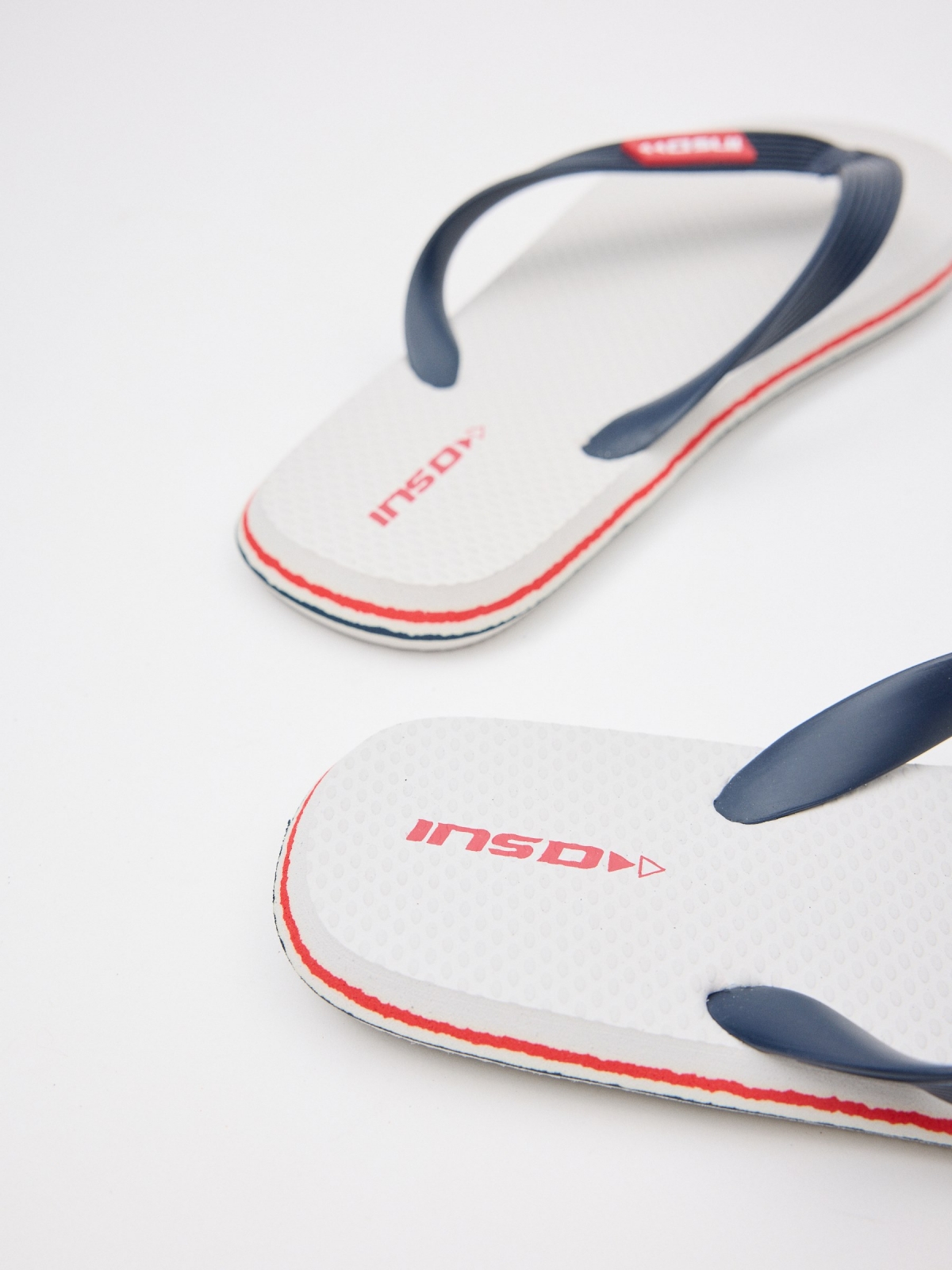 White toe flip flop with engraved strips white detail view