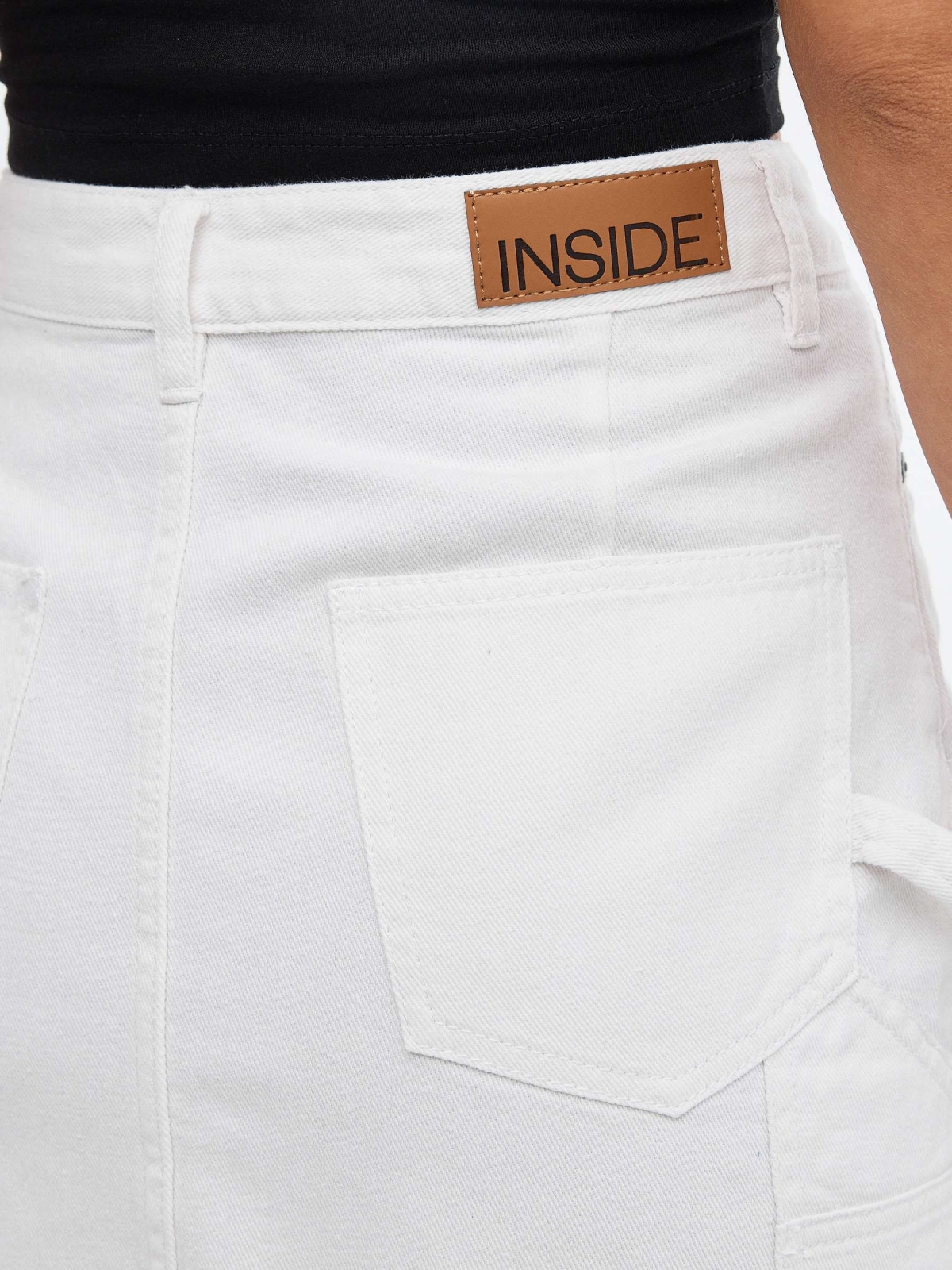 Denim skirt with pleated hem white detail view
