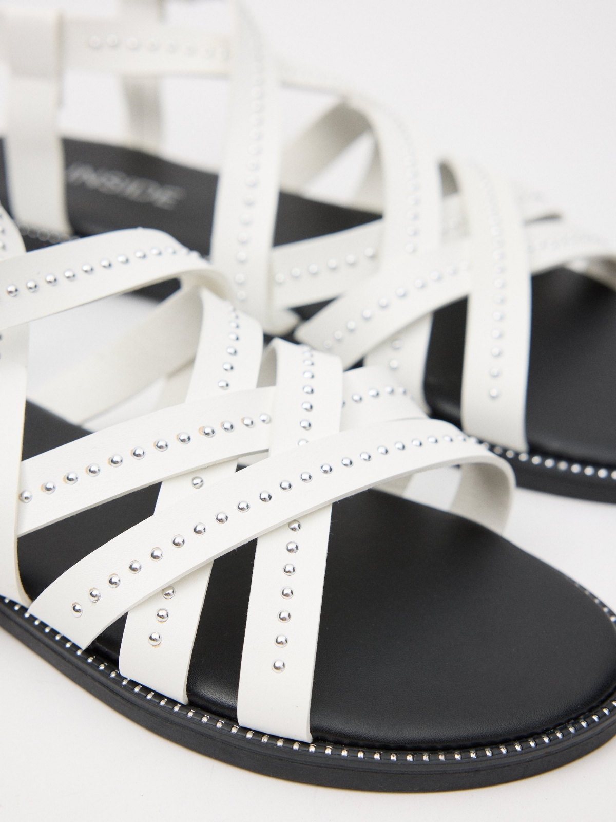 Sandal with crossed straps and studs white detail view