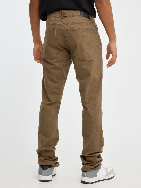Coloured slim jeans brown middle back view