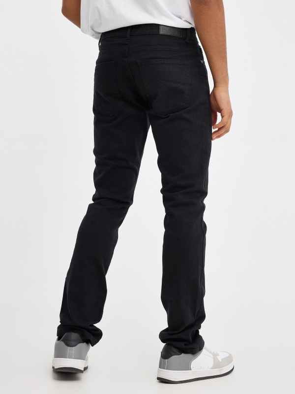 Coloured slim jeans black middle back view