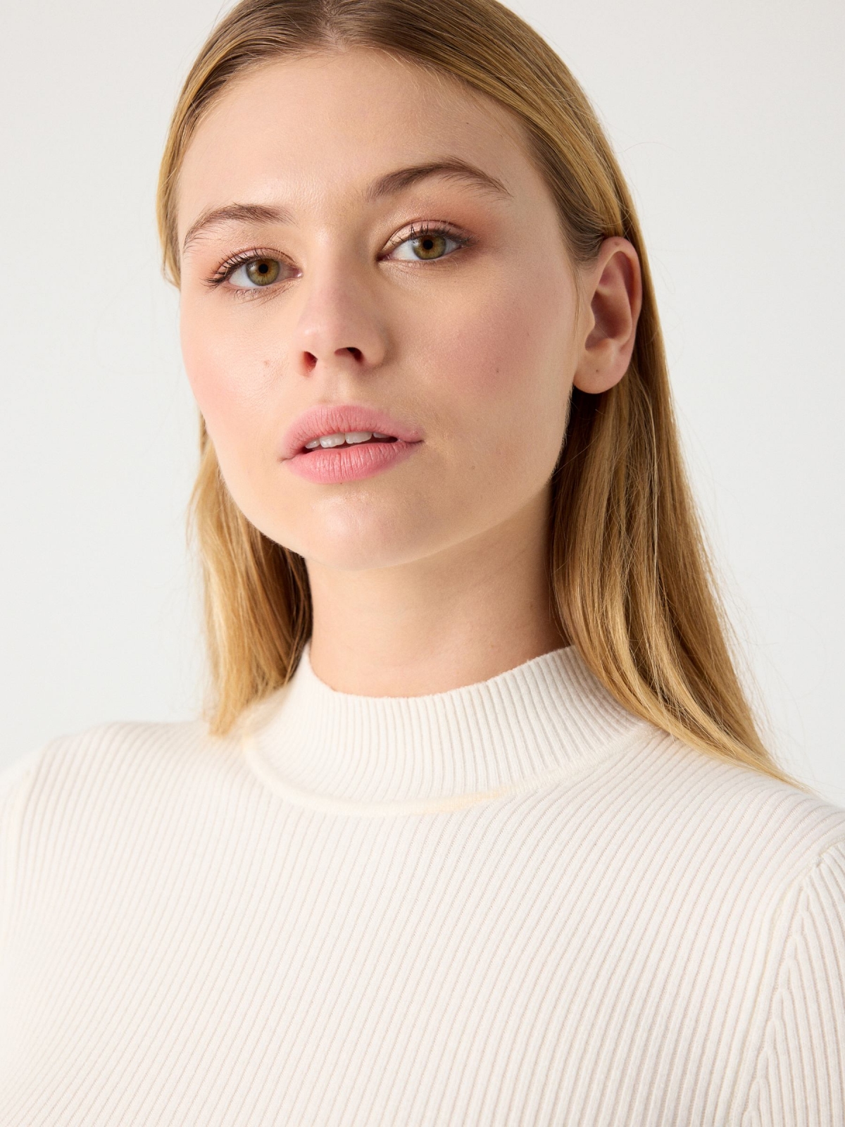 Black sweater with turtleneck off white detail view