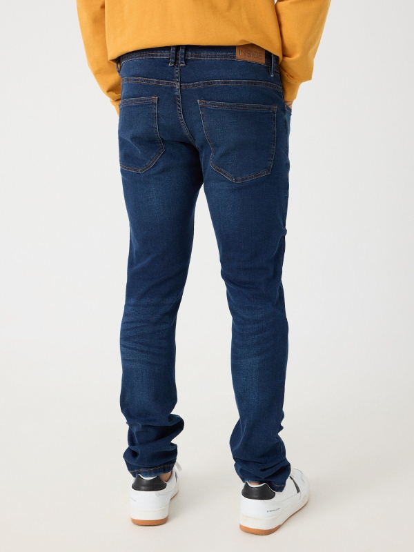 Dark denim slim jeans blue middle back view
