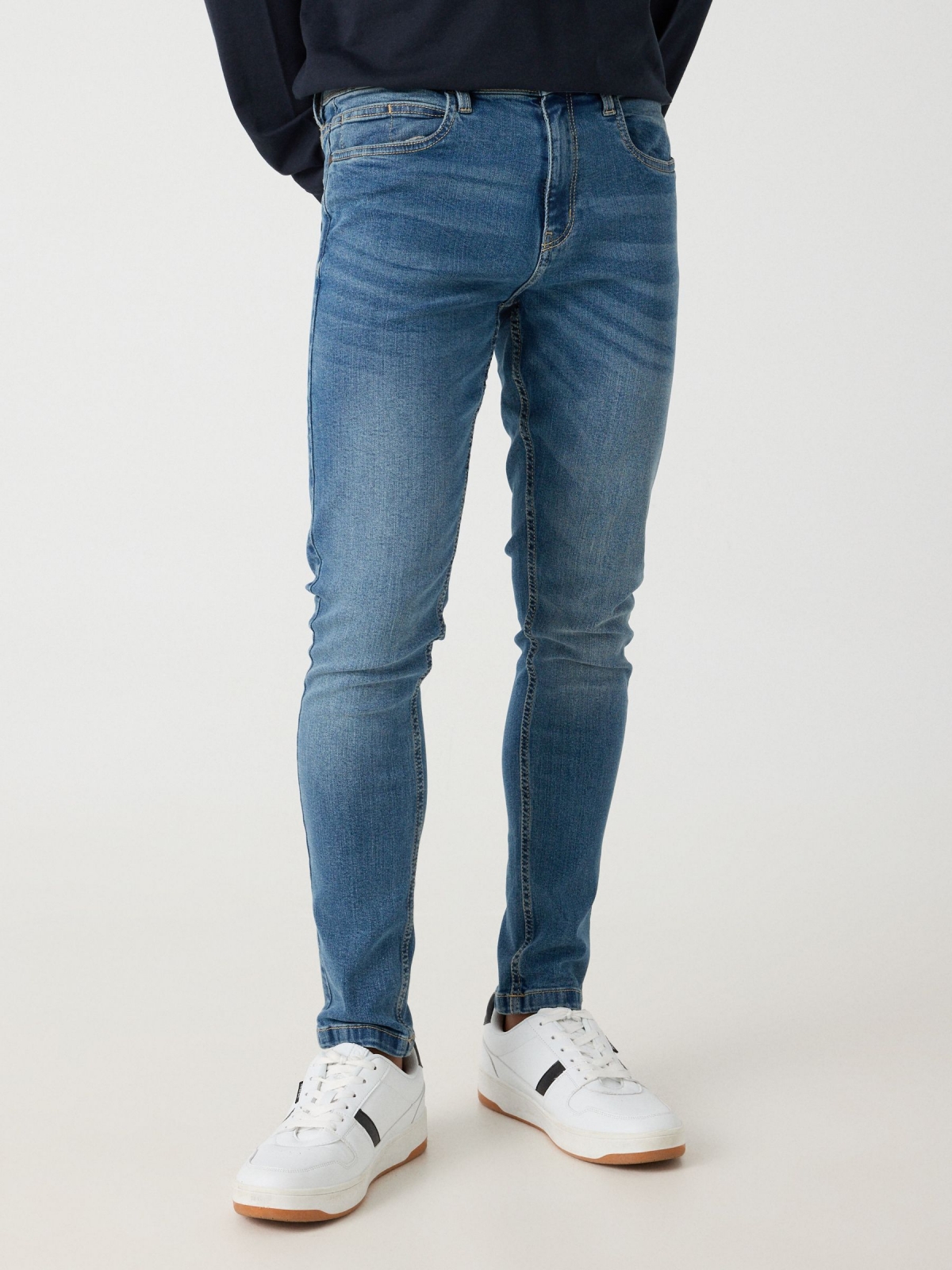 Worn skinny jeans blue middle front view