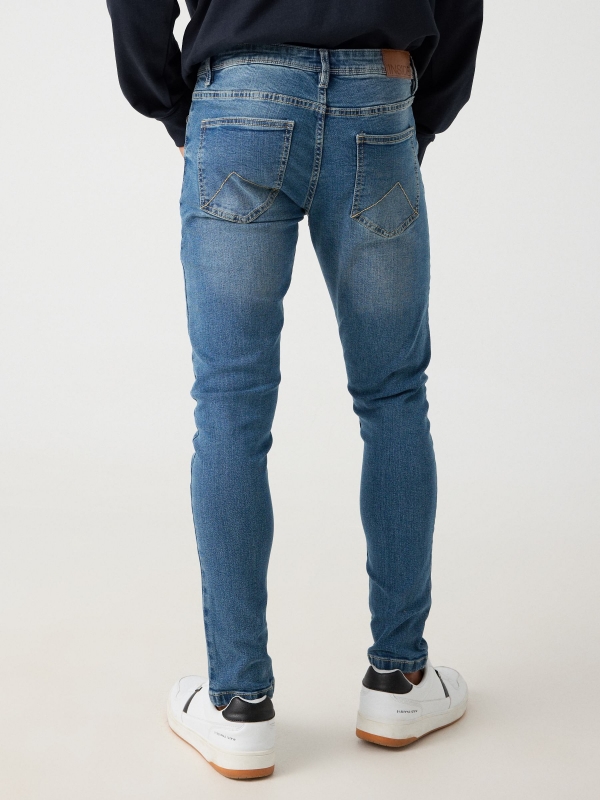 Worn skinny jeans blue middle back view