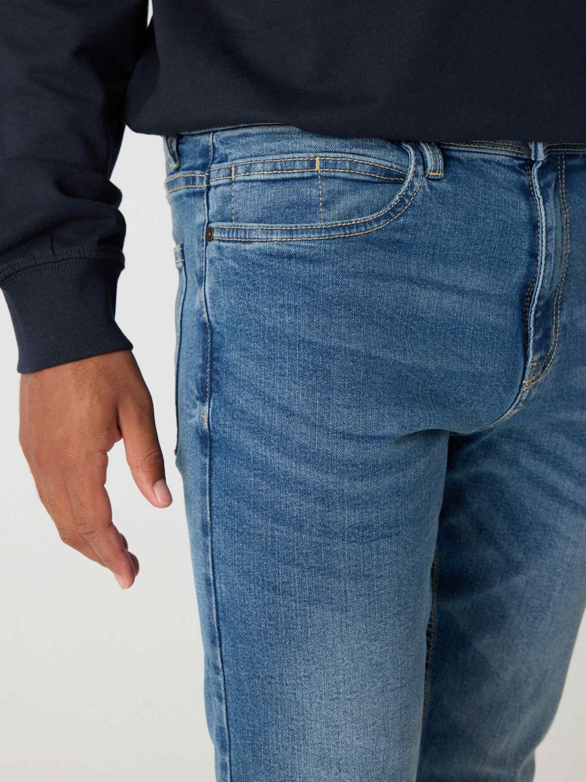 Worn skinny jeans blue detail view