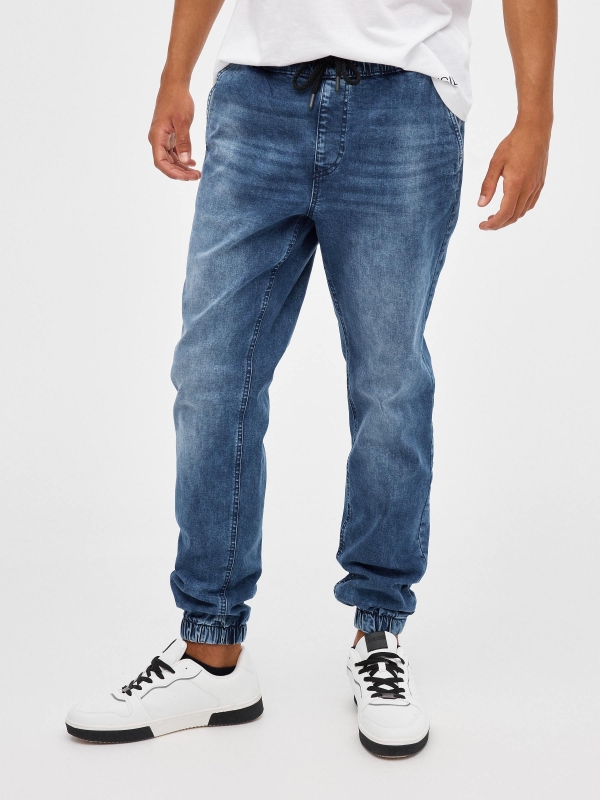 Denim jogger pants with rips blue middle front view