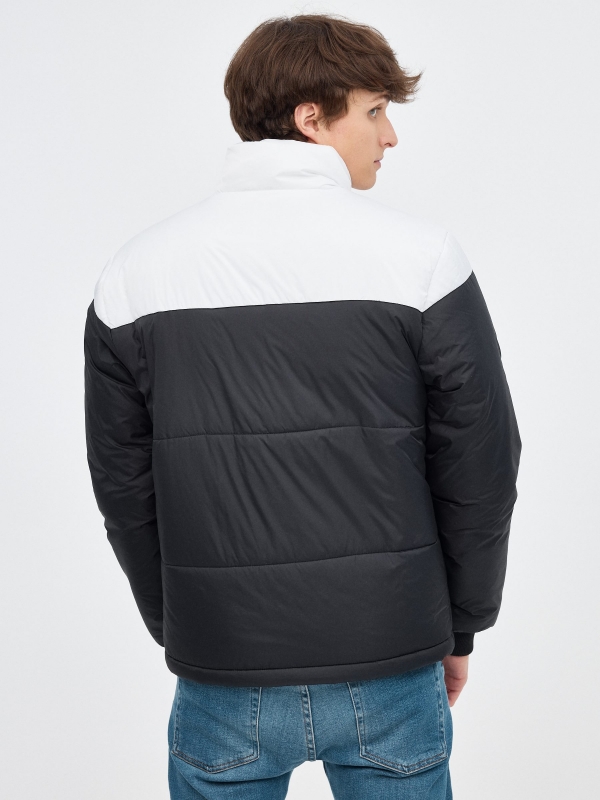 Block color quilted jacket black middle back view