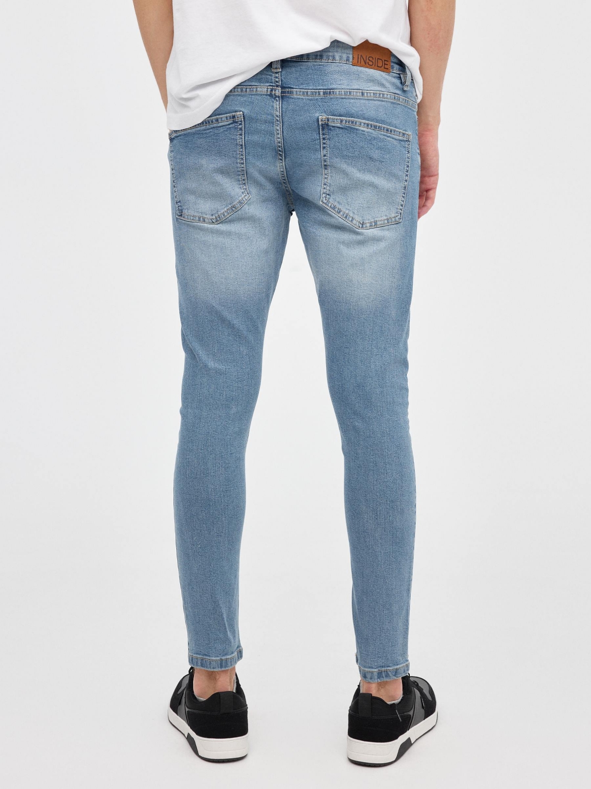 Ripped denim skinny jeans blue middle back view