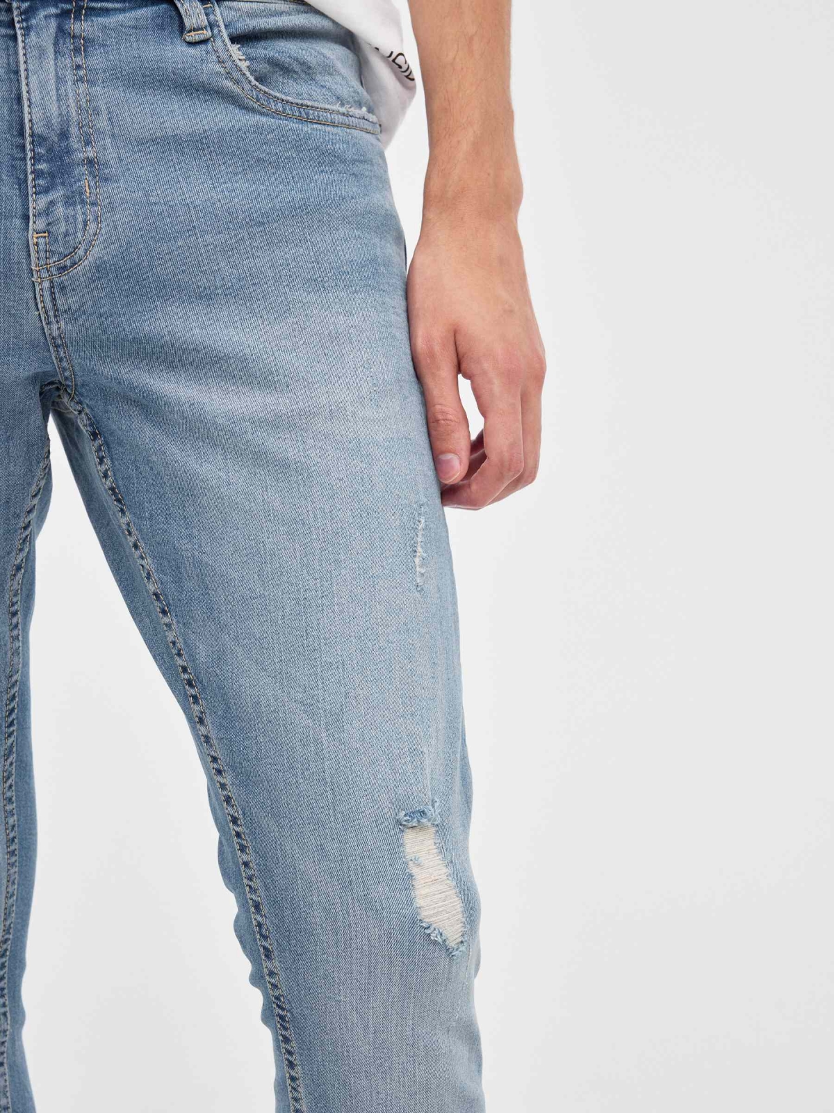 Ripped denim skinny jeans blue detail view