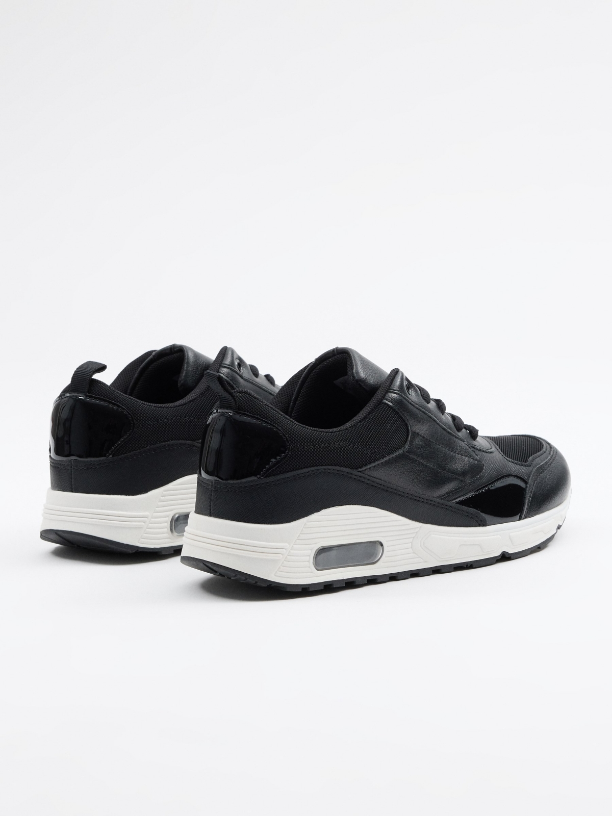 Black sneaker with air chamber black 45º back view