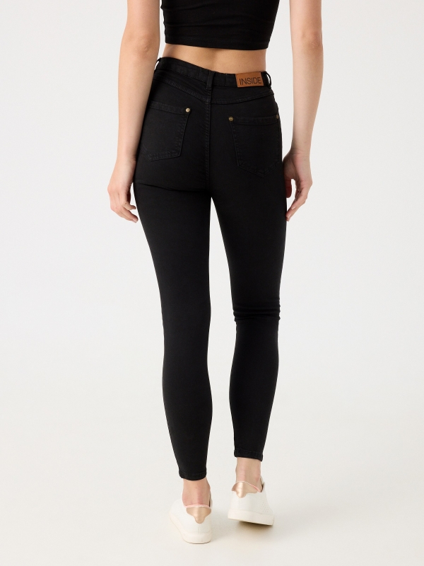 High rise skinny pants black middle back view