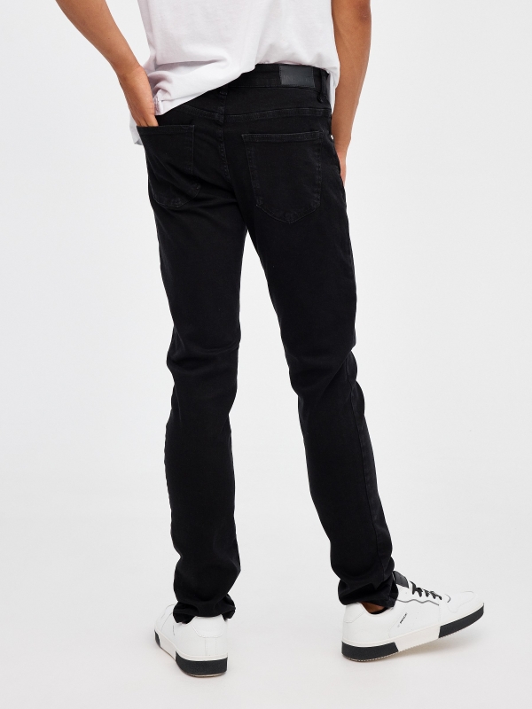 Black denim slim jeans black middle back view
