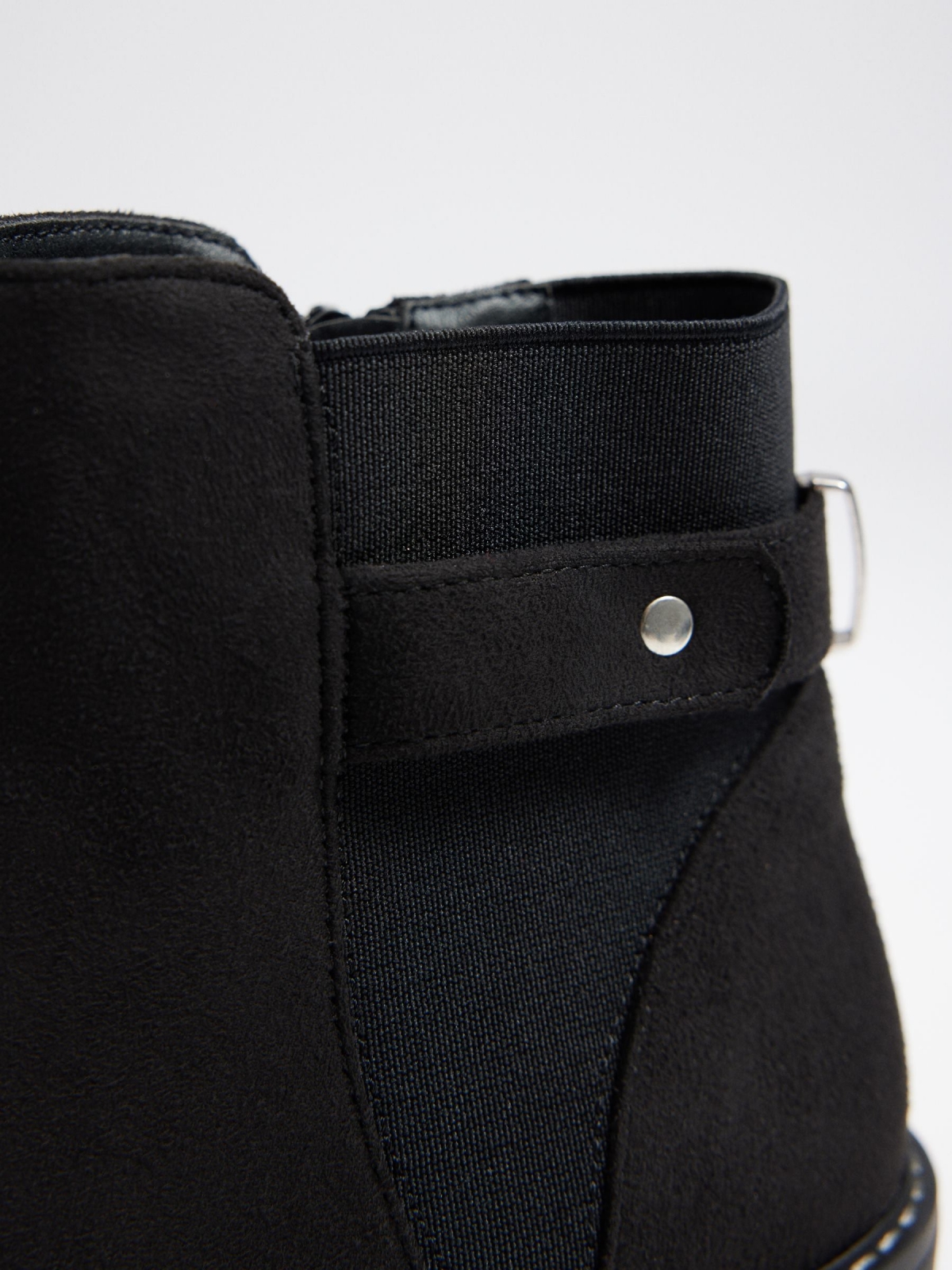 Wedge and buckle boots detail view