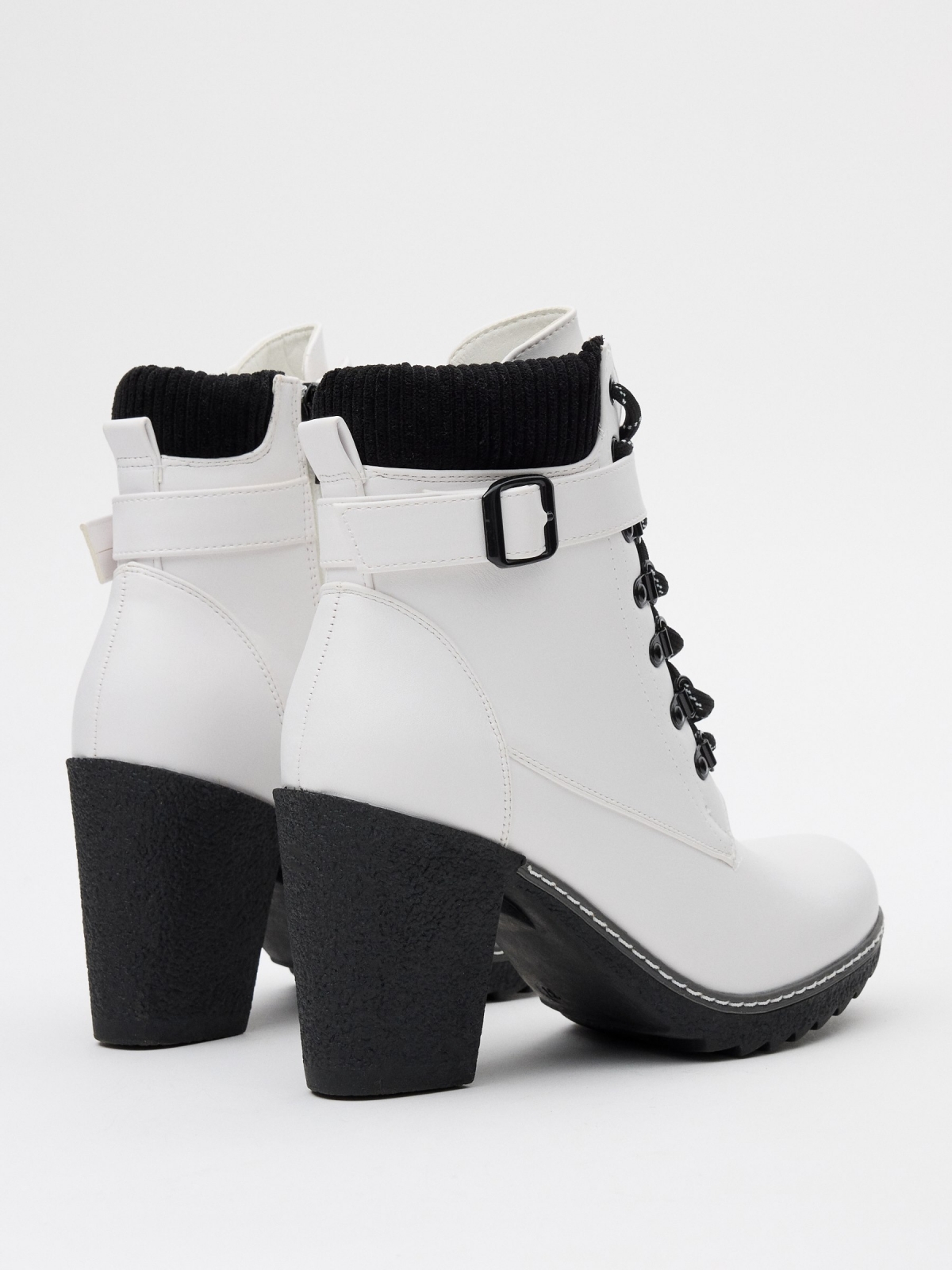 Black and white leatherette ankle boots white 45º back view