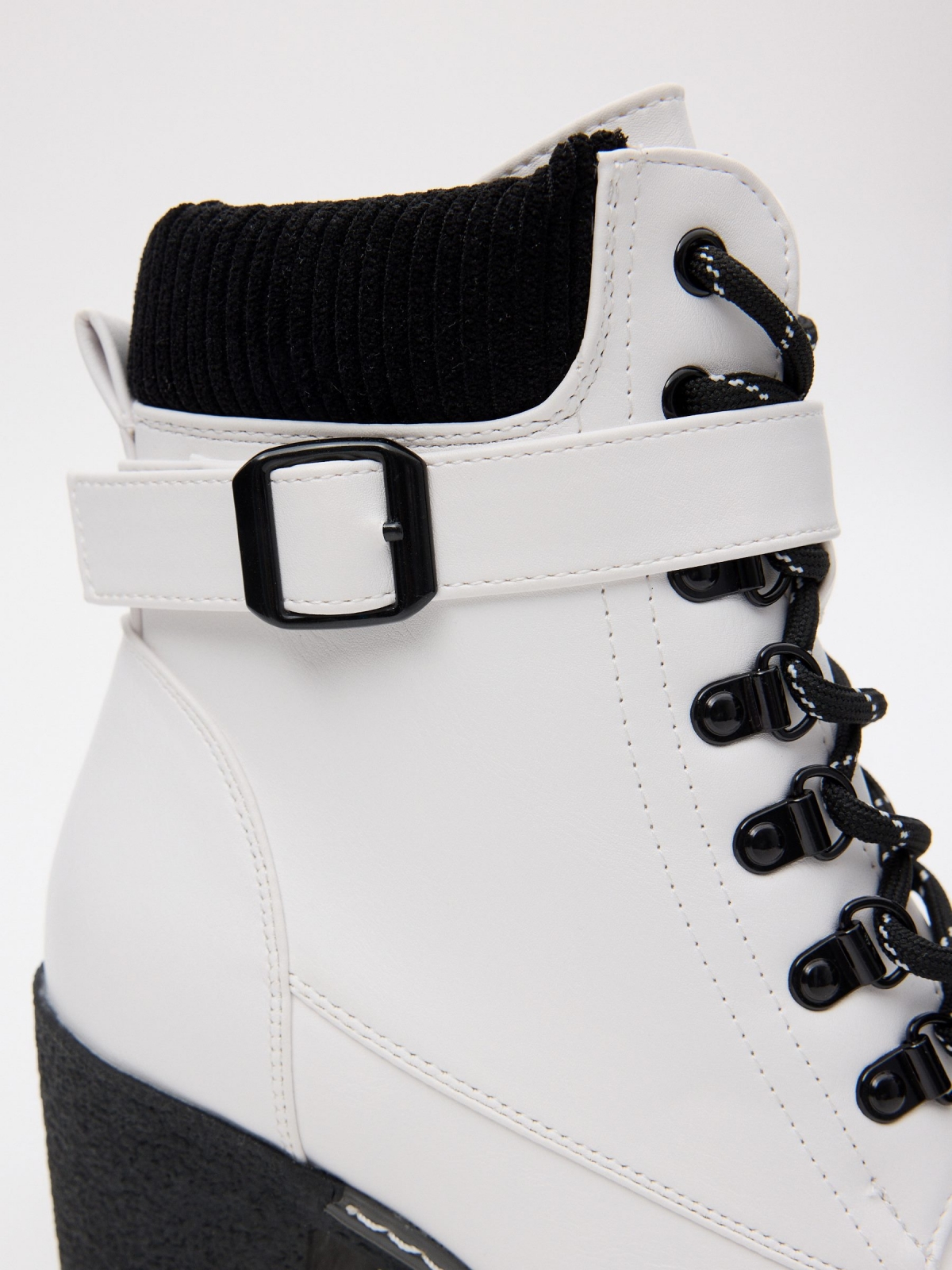 Black and white leatherette ankle boots white detail view