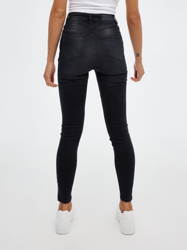 Black high rise skinny jeans black middle back view