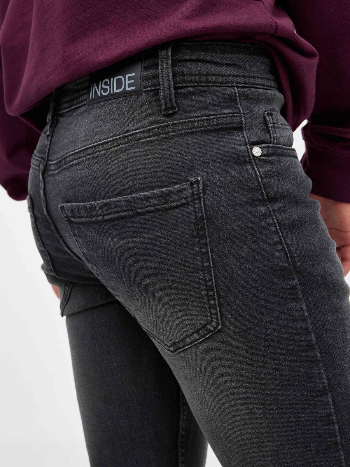Dark denim skinny jeans black detail view